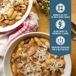 Prepared Sfoglini Cavatelli pasta with beans in a soup in bowls. With product feature icons and text - Bronze die cut to hold more sauce. Slow dried to preserve flavor. Premium semolina for a better bite.