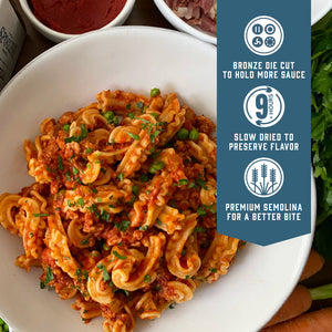 Prepared Sfoglini Cascatelli by Sporkful pasta with ragu meat sauce and peas on a dish. With product feature icons and text - Bronze die cut to hold more sauce. Slow dried to preserve flavor. Premium semolina for a better bite.