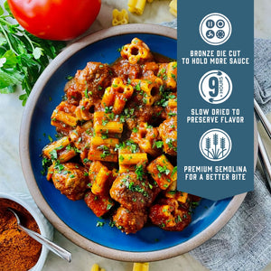 Prepared Sfoglini Quattrotini by Sporkful pasta with meatballs and tomato sauce on a dish. With product feature icons and text - Bronze die cut to hold more sauce. Slow dried to preserve flavor. Premium semolina for a better bite.