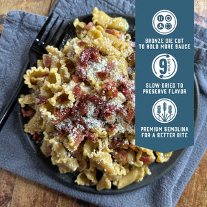 Prepared Sfoglini Whole Grain Trumpets pasta with bacon and cheese on a dish. With product feature icons and text - Bronze die cut to hold more sauce. Slow dried to preserve flavor. Premium semolina for a better bite.