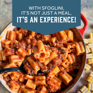 Prepared Sfoglini Quattrotini by Sporkful pasta with red meats auce on spoon with pot of pasta in background on a dish. With text  - WITH SFOGLINI, IT'S NOT JUST A MEAL, IT'S AN EXPERIENCE!
