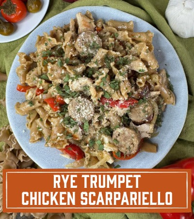Sfoglini Pasta Recipe: Rye Trumpet Chicken Scarpariello. Pasta on a plate with sausage, chicken, and peppers