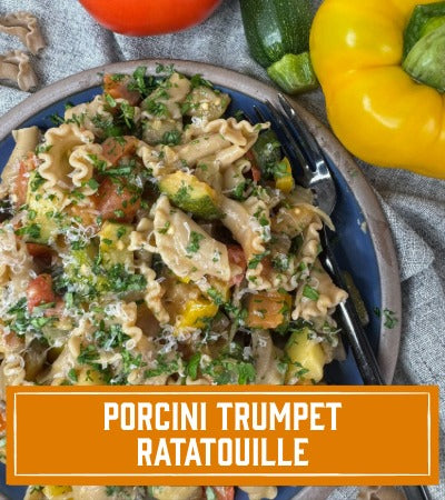 Sfoglini Pasta Recipe: Porcini Trumpet Ratatouille. Pasta with vegetables and herbs on a blue plate