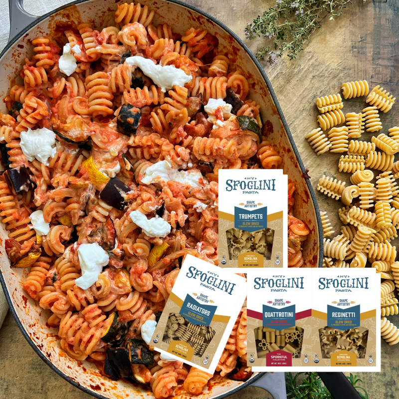 Sfoglini Semolina Specialty Pasta Sampler - Trumpets, Reginetti, Quattrotini, Reginetti pasta boxes on finished pasta dish