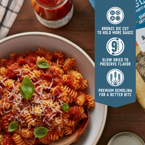 Prepared Radiators pasta dish with sauce and basil.  With product feature icons and text - Bronze die cut to hold more sauce. Slow dried to preserve flavor. Premium semolina for a better bite.